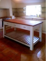 White hand painted in frame kitchen with table style central unit designed and fitted by Barrett Kitchens, County Donegal, Ireland